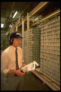 506071 Checking Inventory In A Warehouse A4 Photo Print