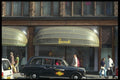 512027 Black Cab Outside The Famous Harrods Store, Brompton Road A4 Photo Print
