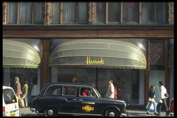 512027 Black Cab Outside The Famous Harrods Store, Brompton Road A4 Photo Print