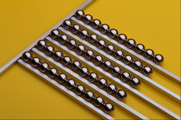 530094 Steel Balls And Rods On Yellow Acrylic A4 Photo Print