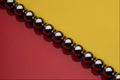 530095 Steel Balls On Red And Yellow Acrylic A4 Photo Print