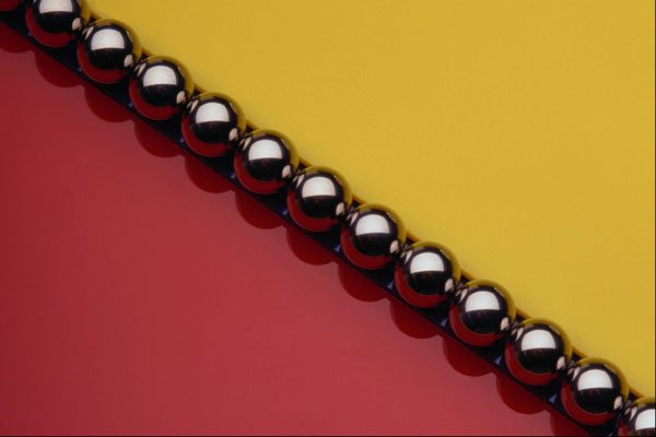 530095 Steel Balls On Red And Yellow Acrylic A4 Photo Print