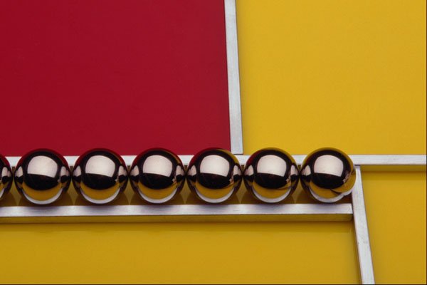 530097 Steel Balls And Rods On Red And Yellow Acrylic A4 Photo Print