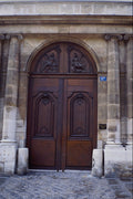 549027 Brown Door With Two Allegorical Figures A4 Photo Print