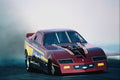 573023 A Jet powered Funny Car Obscures The Track In Thick Smoke A4 Photo Print