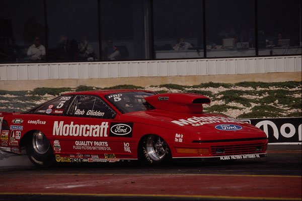 573043 A Sleek, Red Ford Pro Stock Heats Up Its Rear Tires A4 Photo Print