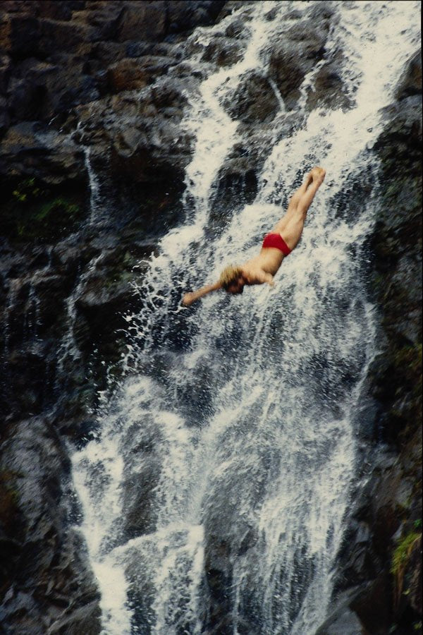 589054 Cliff Divers Against Waterfall A4 Photo Print