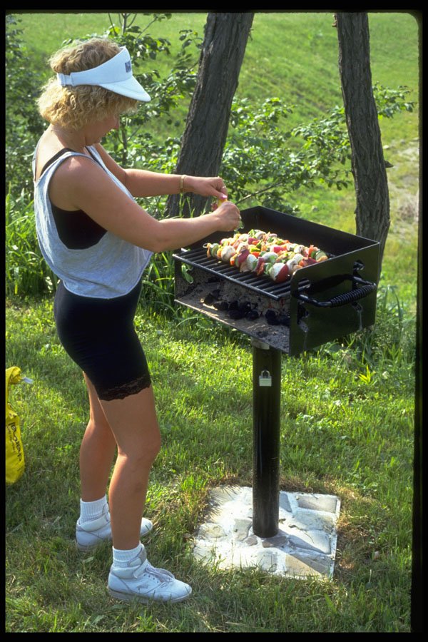 592000 Young Woman Cooking Shish Kabob, New York A4 Photo Print