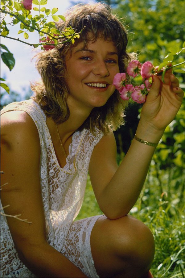 592033 Girl Sniffing Flowers A4 Photo Print