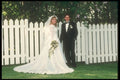 598015 Bride And Groom In Front Of White Picket Fence A4 Photo Print