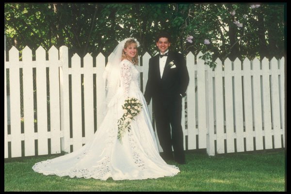 598015 Bride And Groom In Front Of White Picket Fence A4 Photo Print