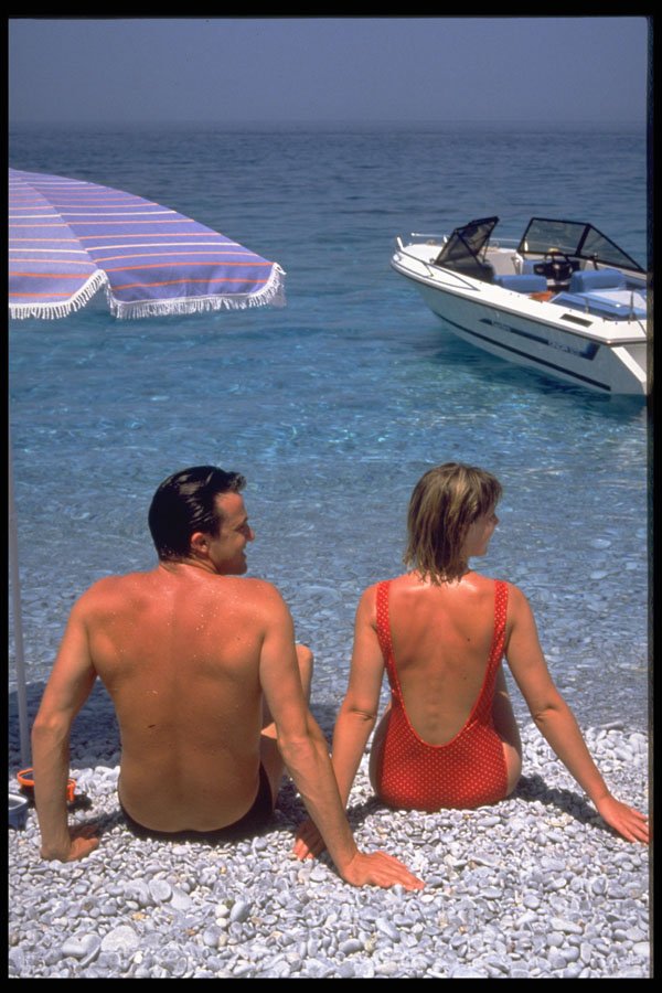 598030 Couple On Pebble Beach, Greece A4 Photo Print