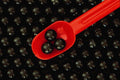 616078 Black Marbles, Red Spoon A4 Photo Print