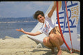 626011 Woman Crouching, Hand Out, St. Tropez A4 Photo Print