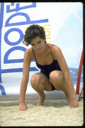 626012 Woman Crouching In Black Swimsuit, St. Tropez A4 Photo Print
