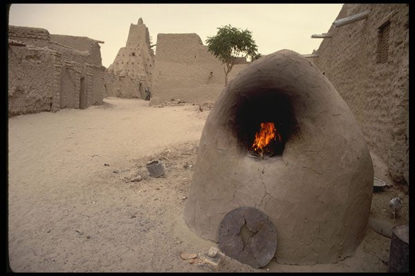 629071 Timbuktu Street Scene With Lighted Sand Oven, Mali A4 Photo Print