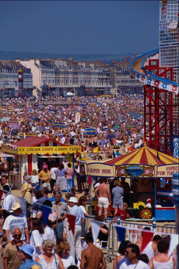 633068 Crowded Weymouth Seafront With Fun Fair Rides, England A4 Photo Print