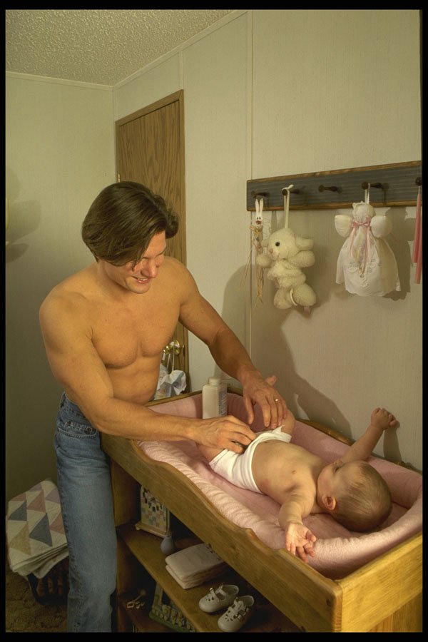 635012 Father Changing Baby's Diaper A4 Photo Print