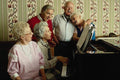 635058 Retired Folks Singing Around The Piano A4 Photo Print