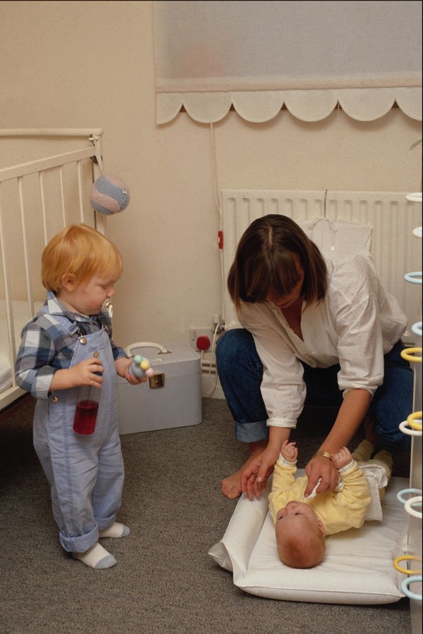 635087 Mother Changing Baby On Floor A4 Photo Print