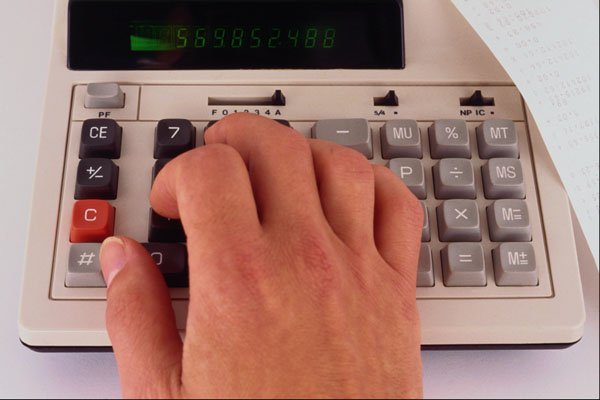 643057 Desk Calculator In Use A4 Photo Print