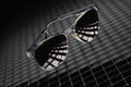 643062 Sunglasses On Grid Background A4 Photo Print