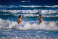 647000 Girls Playing In The Surf A4 Photo Print