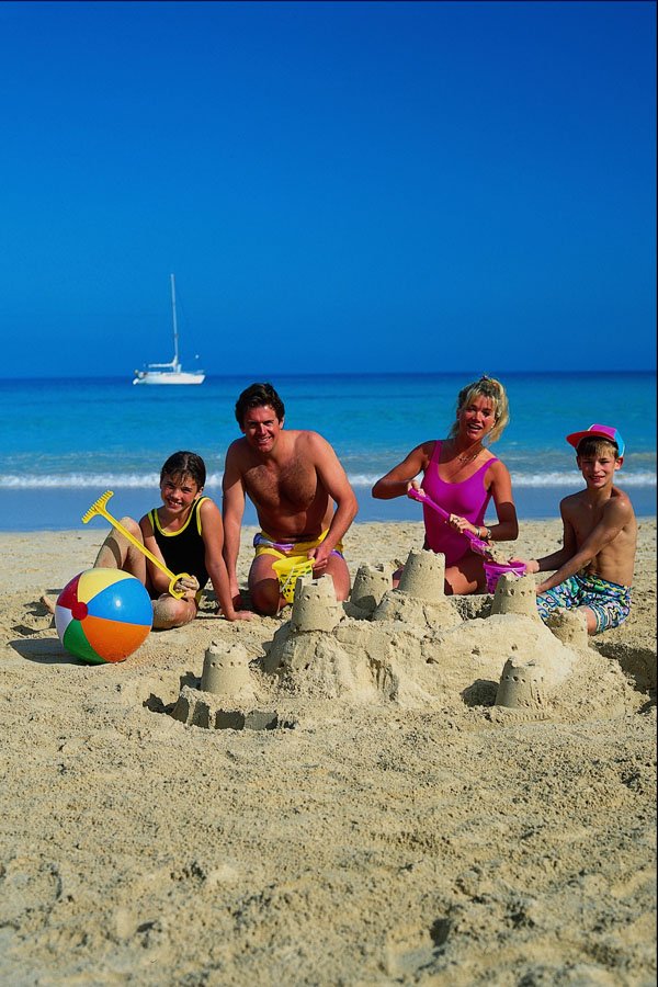 647079 Family Building Sandcastle On Beach, Playa Blanca, Spain A4 Photo Print