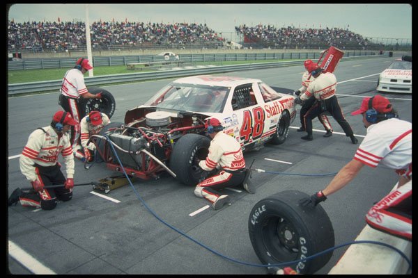 648009 Crewmen Work To Get A Battered Car Back Into The Race A4 Photo Print
