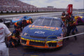 648072 Mechanics Hurry To Get Their Driver Out As Other Cars Exit A4 Photo Print