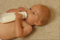 651001 Young Baby With Bottle A4 Photo Print