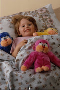 651073 Child In Bed With Colored Soft Toys A4 Photo Print