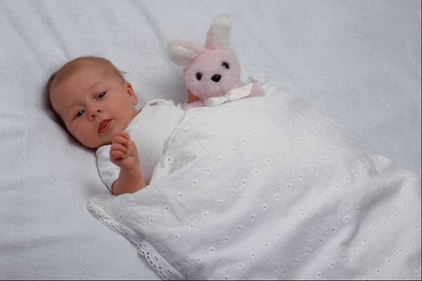 651074 Baby In Bed With Pink Rabbit A4 Photo Print