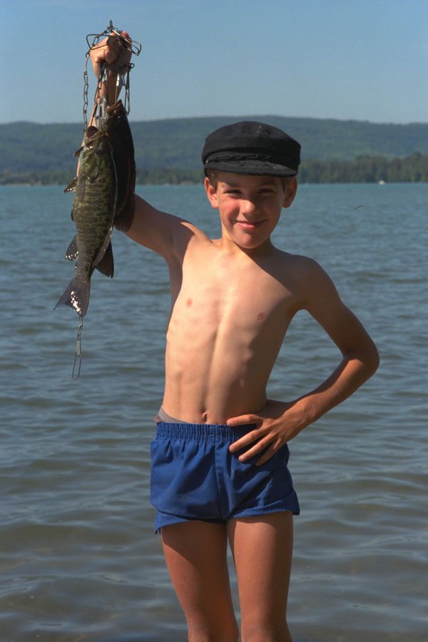 651083 Young Boy Proudly Hoists His First Catch Of Bass A4 Photo Print