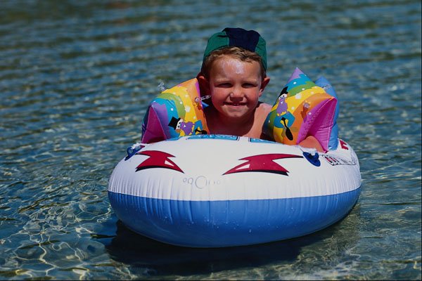 651091 Boy In Plastic Boat A4 Photo Print