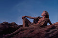 657034 Woman Reclining On Desert Cliff Rocks A4 Photo Print