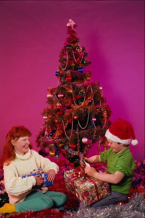 658034 Opening Presents By Christmas Tree A4 Photo Print