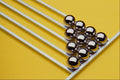 662057 Steel Balls And Rods On Yellow Acrylic A4 Photo Print