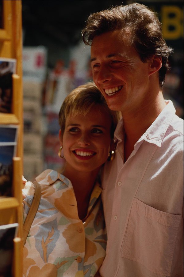 673095 Happy Couple Looking At Holiday Postcards A4 Photo Print