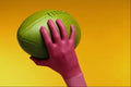 675041 Magenta Gloved Hand And Green Football A4 Photo Print