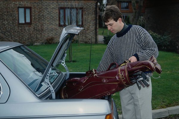 681095 Man Loading Golf Clubs Into Car A4 Photo Print