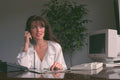 682040 Woman Working At Her Desk While On The Phone A4 Photo Print
