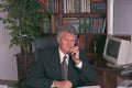 682041 Professional Man Sitting At Executive Desk A4 Photo Print