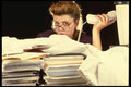 682066 Businesswoman With Stacks Of Paperwork A4 Photo Print