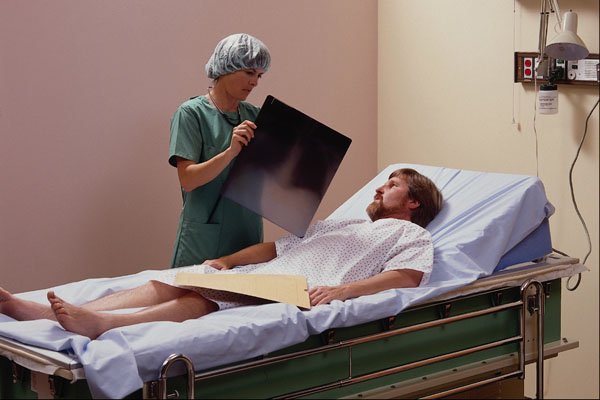 686052 Patient In Hospital Bed Being Shown X ray A4 Photo Print