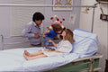 686054 Father And Son Visiting Mother In Hospital A4 Photo Print