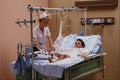 686055 Patient Being Cared For By Nurse In Hospital A4 Photo Print