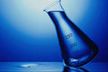 686082 Laboratory Flask On Rippled Liquid A4 Photo Print