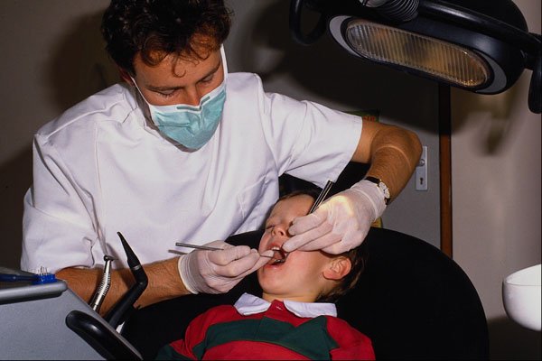 686095 Dentist Performs Check up On Child A4 Photo Print
