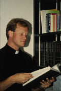 690015 Clergyman In Library A4 Photo Print